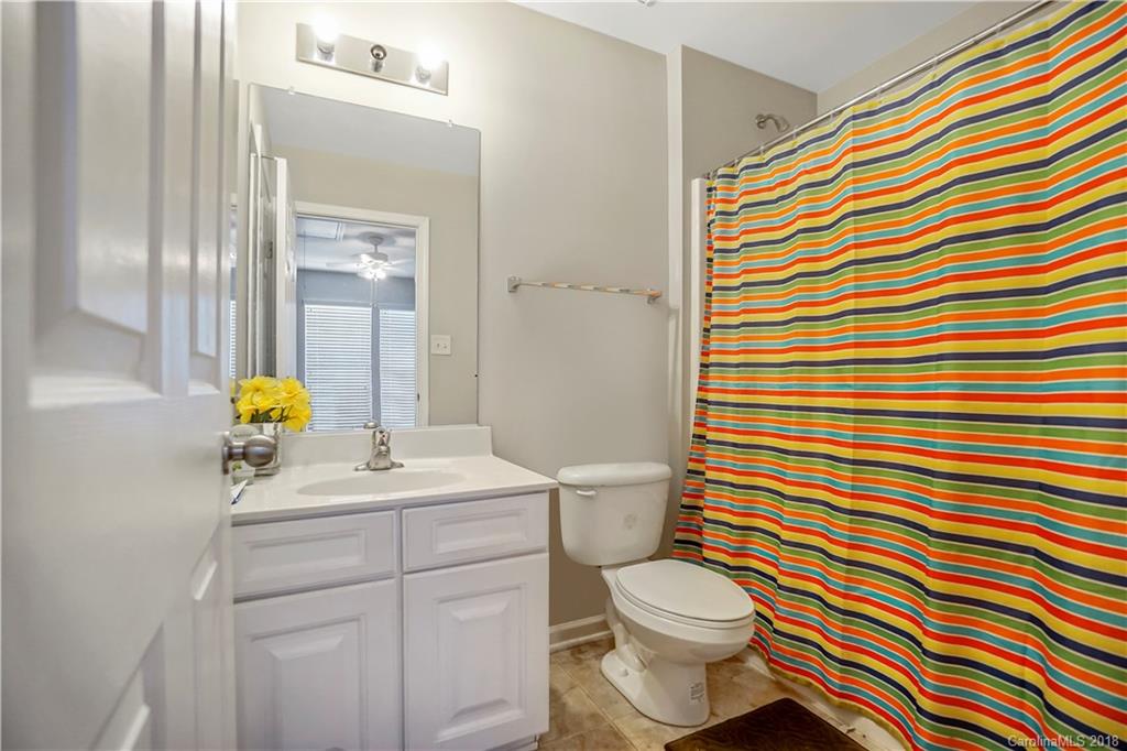 10225 Garrett Grigg Road Charlotte, NC 28262 - Photo 19 of 30 a bathroom with a sink toilet and shower