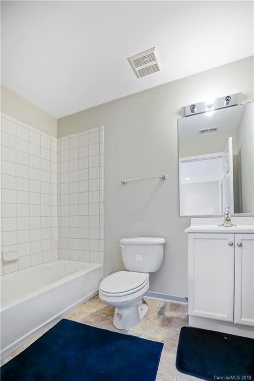 10225 Garrett Grigg Road Charlotte, NC 28262 - Photo 22 of 30 a bathroom with a toilet a sink and bathtub