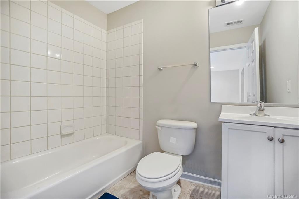 10225 Garrett Grigg Road Charlotte, NC 28262 - Photo 23 of 30 a bathroom with a toilet a sink and bathtub