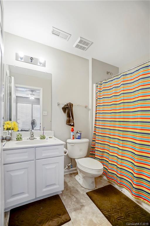 10225 Garrett Grigg Road Charlotte, NC 28262 - Photo 24 of 30 a bathroom with a sink a toilet and a mirror