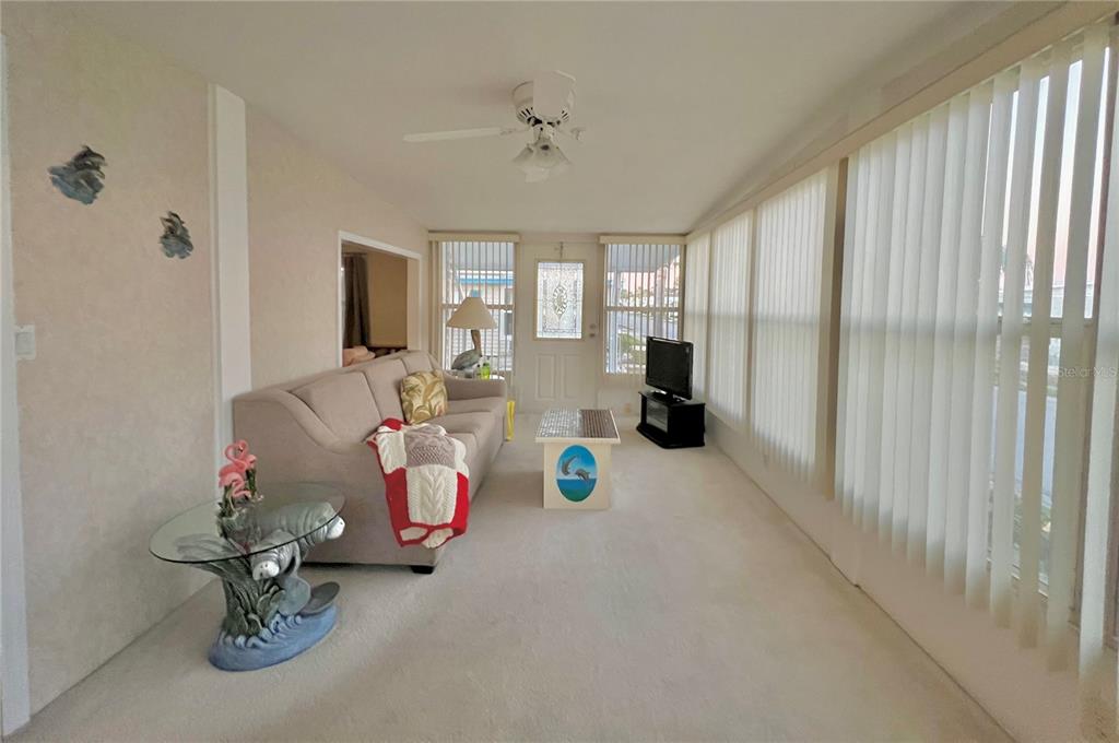 1100 South Belcher Road, Unit 190 Largo, FL 33771 - Photo 6 of 48 a living room with furniture and a chandelier