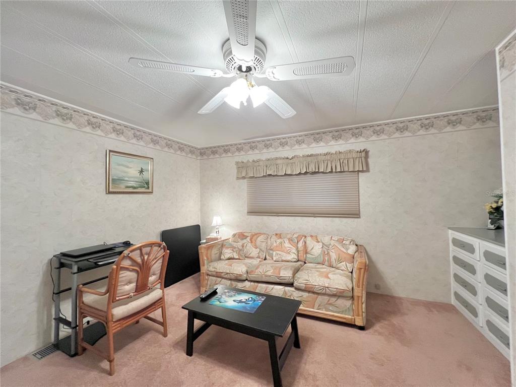 1100 South Belcher Road, Unit 190 Largo, FL 33771 - Photo 9 of 48 a bedroom with furniture and a chandelier