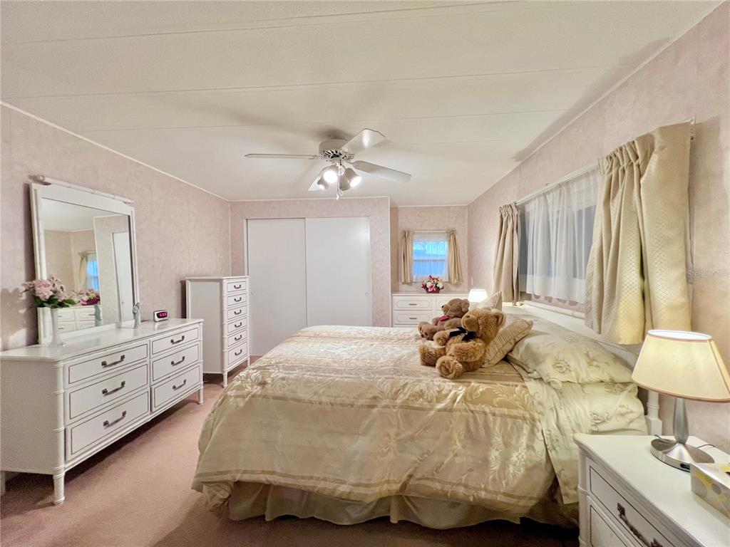 1100 South Belcher Road, Unit 190 Largo, FL 33771 - Photo 10 of 48 a bedroom with a bed and a chandelier