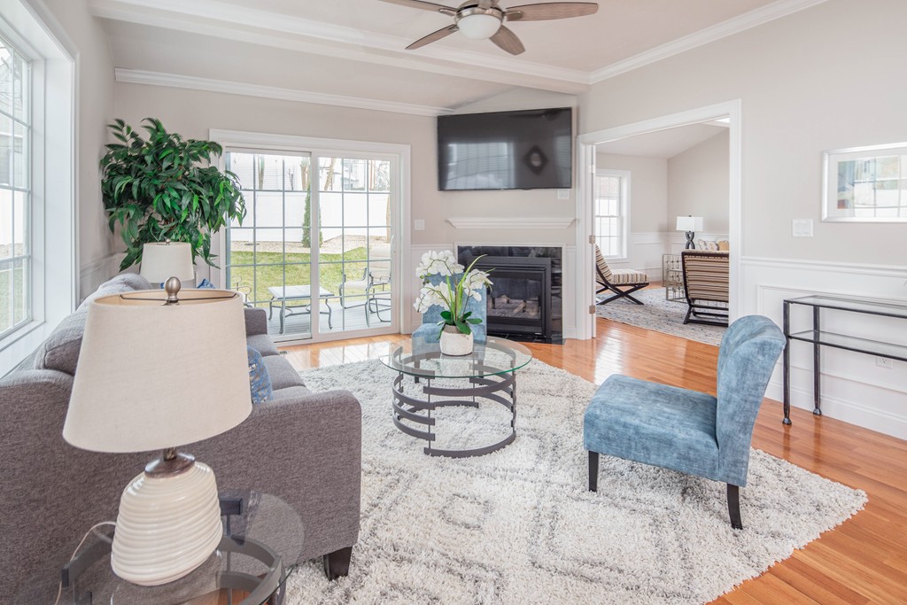 135 Sumner Street, Unit 1 Quincy, MA 02169 - Photo 2 of 13 a living room with furniture and a fireplace