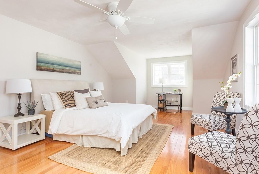 135 Sumner Street, Unit 1 Quincy, MA 02169 - Photo 8 of 13 a bedroom with a large bed and a chandelier