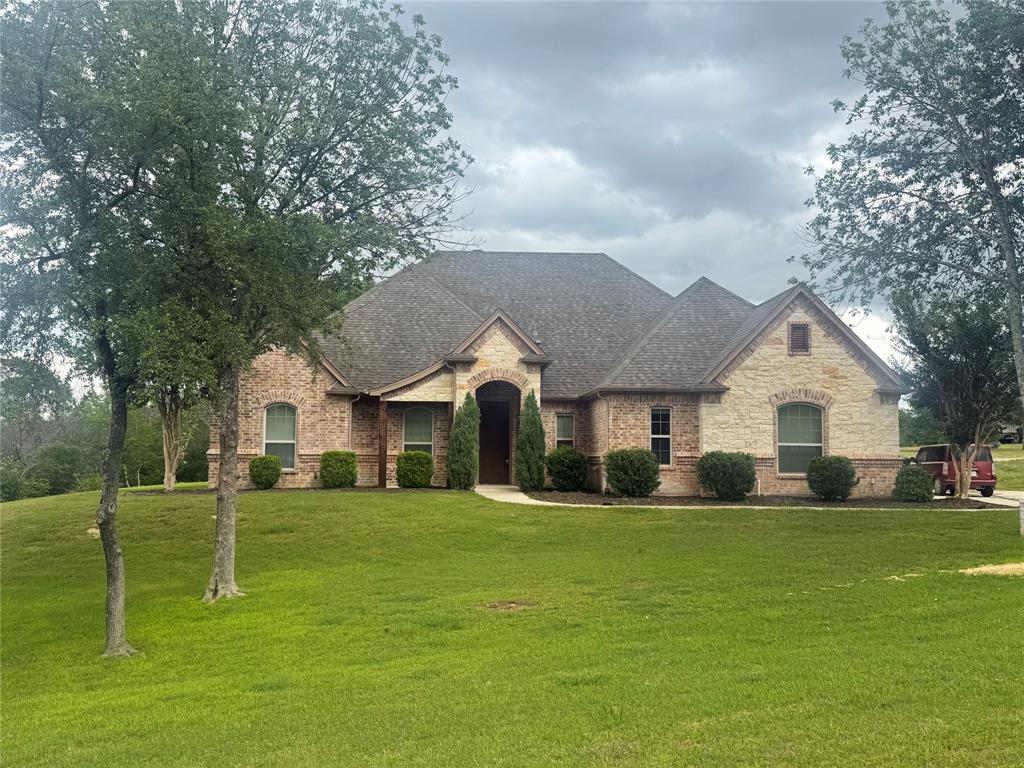 101 Bedding Lane Azle, TX 76020 - Photo 1 of 6 Stone and brick veneer exterior with an arched entryway