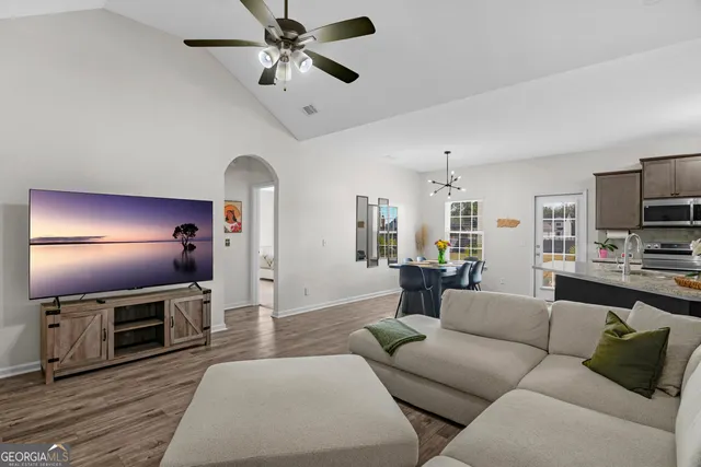 a living room with furniture and a flat screen tv
