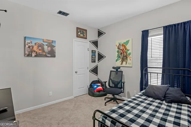 a bedroom with a bed and a bookshelf