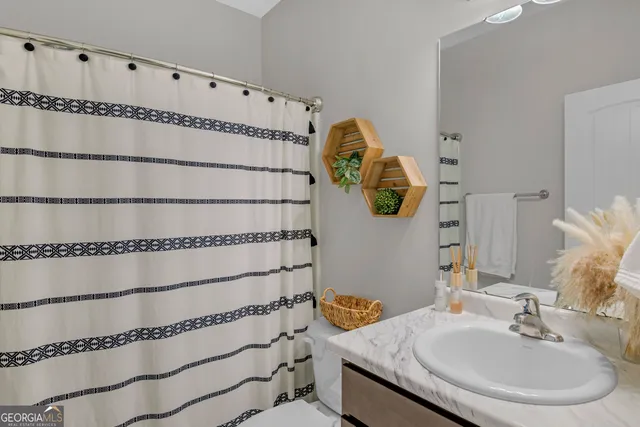 a large bed sitting in a bedroom next to a window