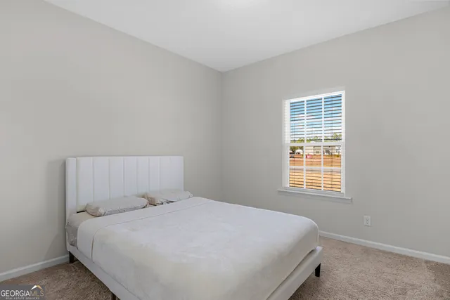 a bedroom with a bed and cabinets