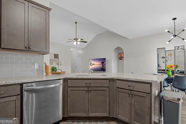 a kitchen with stainless steel appliances cabinets and wooden floor