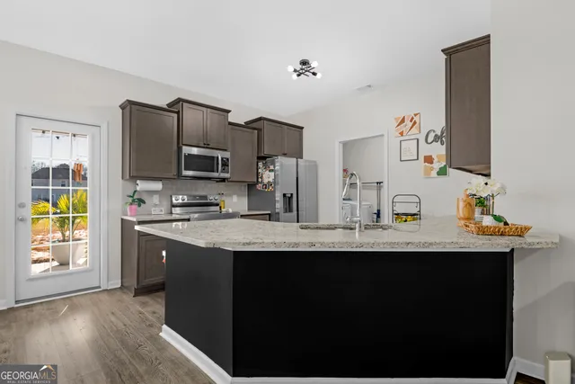 a kitchen with a sink stove and refrigerator