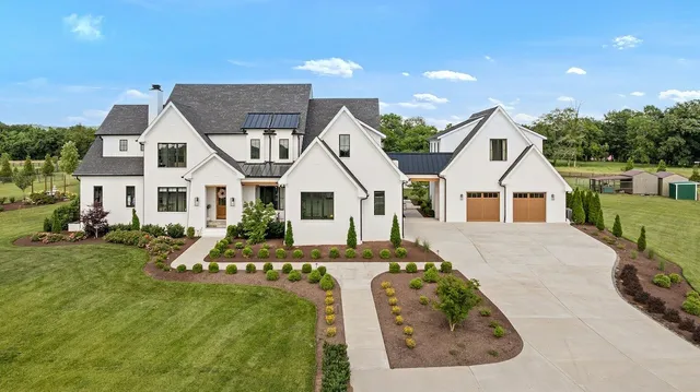 a view of house with yard outdoor seating and covered with furniture