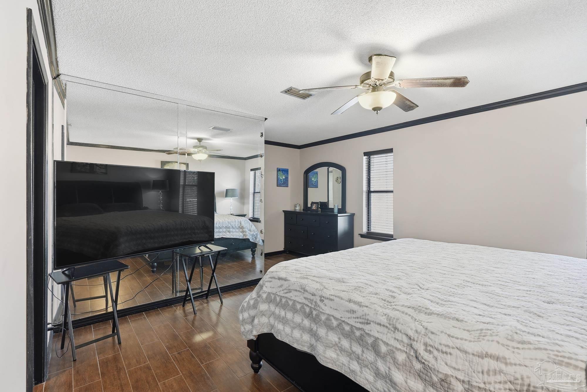 10145 Huntsman Path Pensacola, FL 32514 - Photo 18 of 47 a bedroom with a bed and a flat screen tv