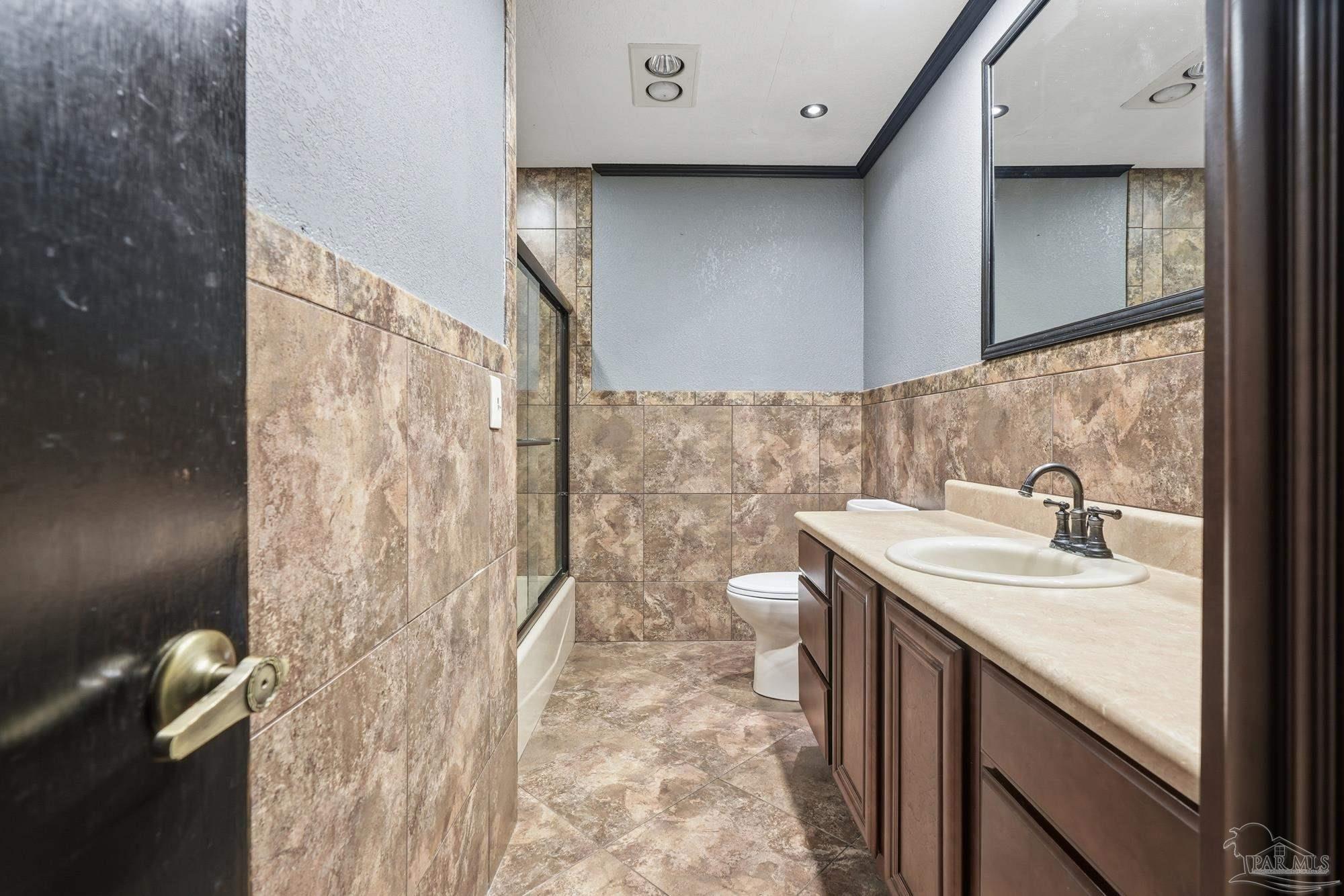 10145 Huntsman Path Pensacola, FL 32514 - Photo 30 of 47 a bathroom with a sink a vanity and a mirror