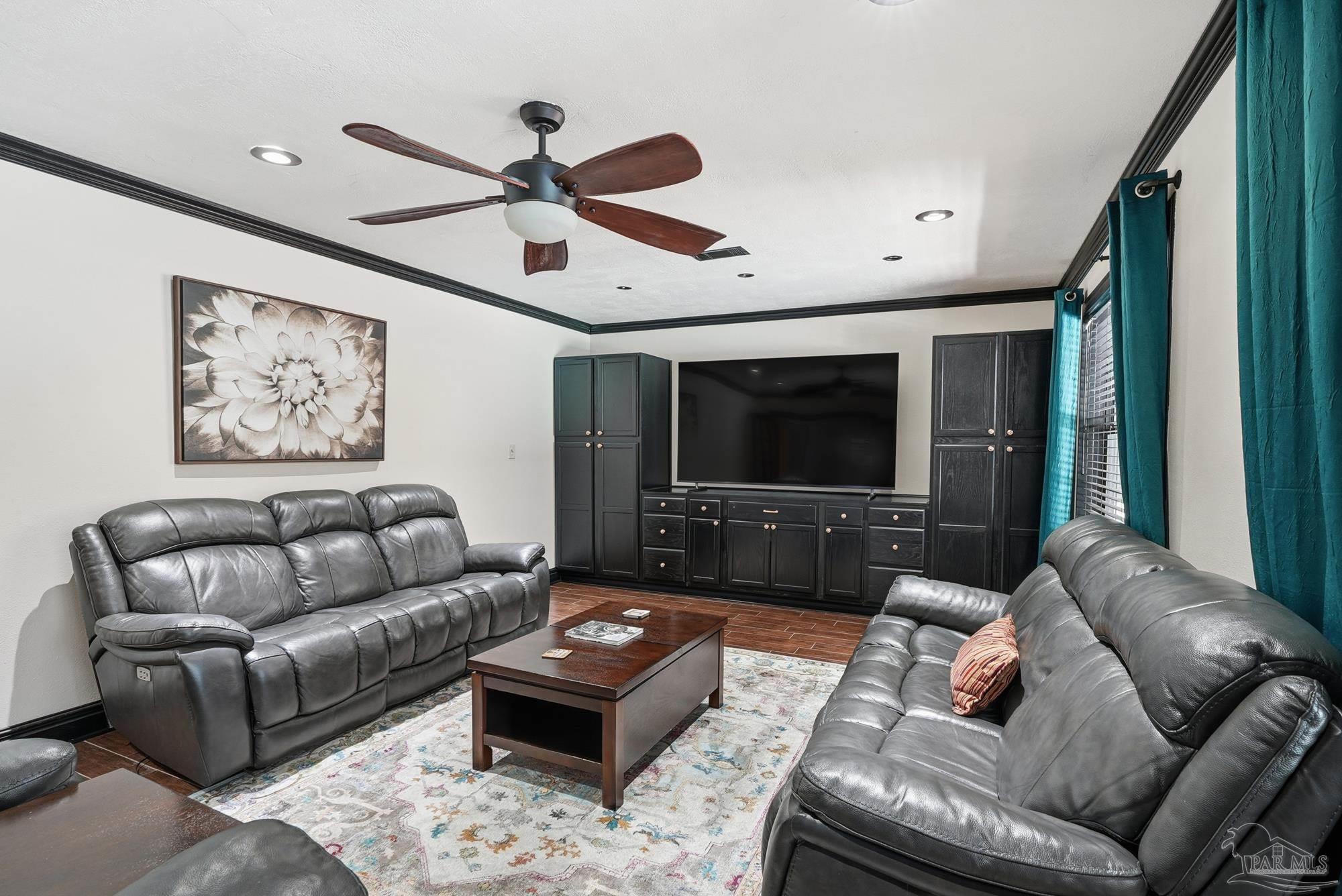 10145 Huntsman Path Pensacola, FL 32514 - Photo 36 of 47 a living room with furniture ceiling fan and a flat screen tv
