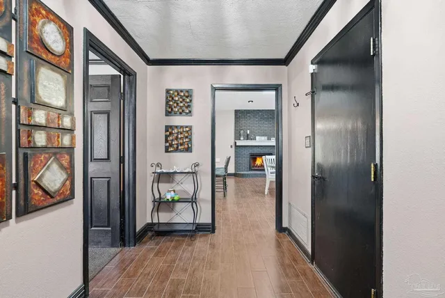 a hallway with wooden floor closet and a bathroom