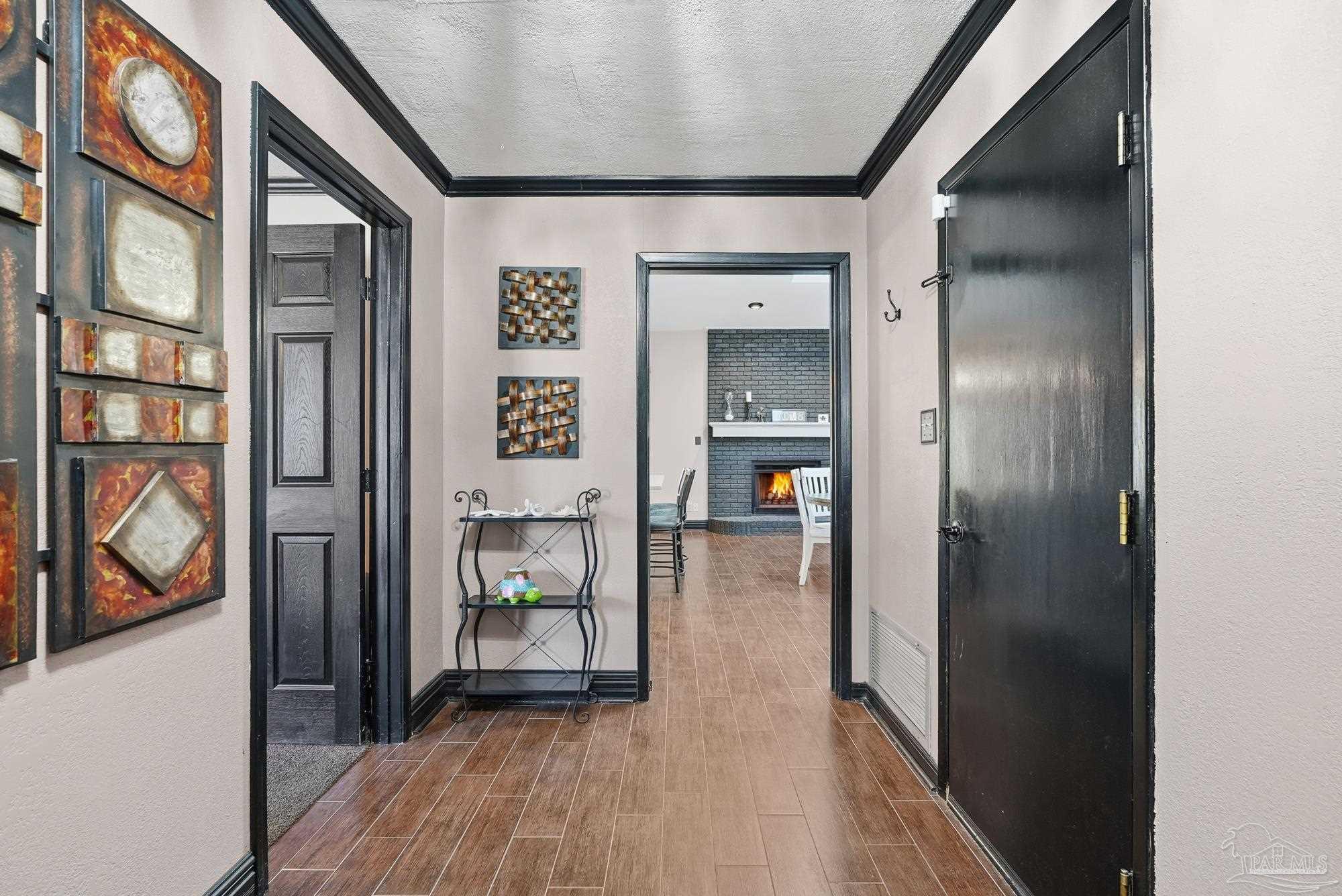 10145 Huntsman Path Pensacola, FL 32514 - Photo 6 of 47 a hallway with wooden floor closet and a bathroom