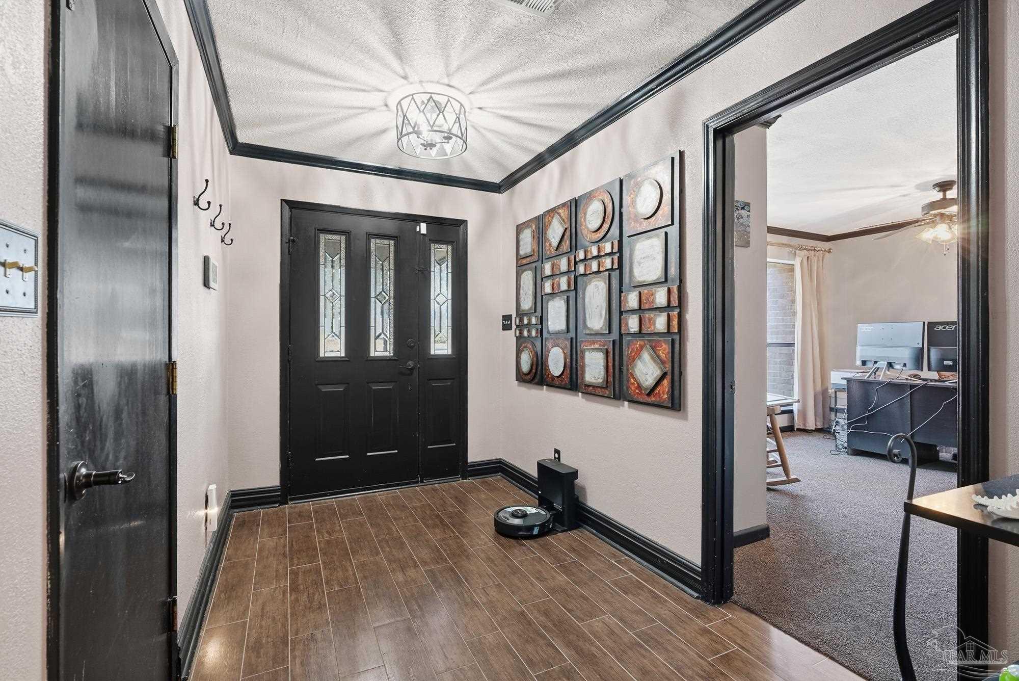 10145 Huntsman Path Pensacola, FL 32514 - Photo 7 of 47 a view of a hallway with wooden floor and livingroom with furniture