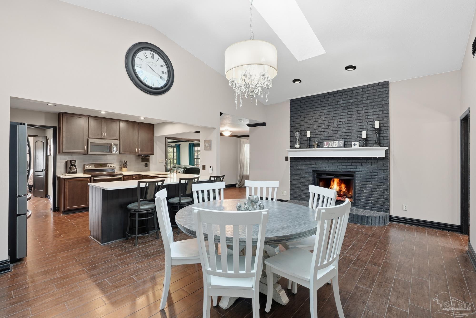 10145 Huntsman Path Pensacola, FL 32514 - Photo 10 of 47 a view of a dining room and livingroom with furniture wooden floor a rug and a clock