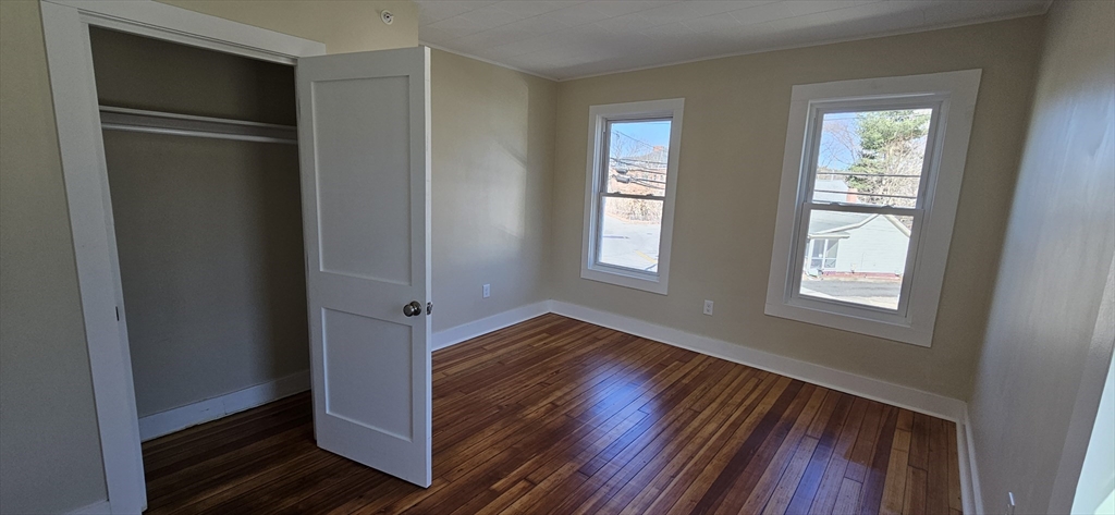 2009 High Street, Unit 2013 Three Rivers, MA 01080 - Photo 1 of 13 a view of an empty room with wooden floor and a window