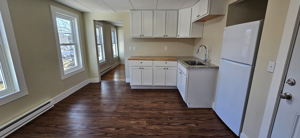 2009 High Street, Unit 2013 Three Rivers, MA 01080 - Photo 4 of 13 a kitchen with granite countertop a refrigerator and a stove top oven