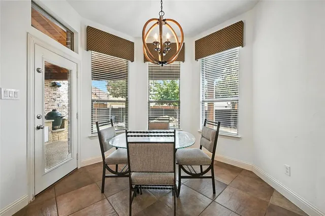 a view of a dining room with furniture and a window