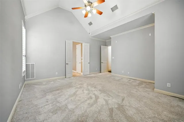 a view of an empty room with a ceiling fan