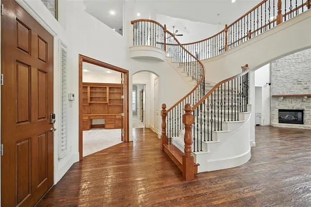 a view of entryway and hall with wooden floor