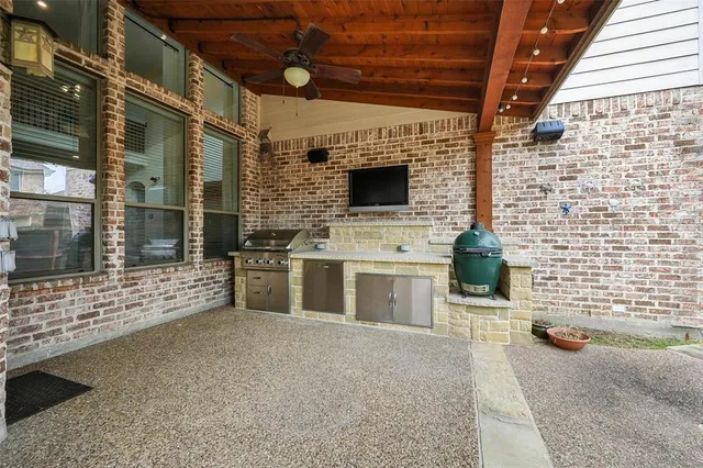 a view of open kitchen with granite countertop white cabinets and stainless steel appliances
