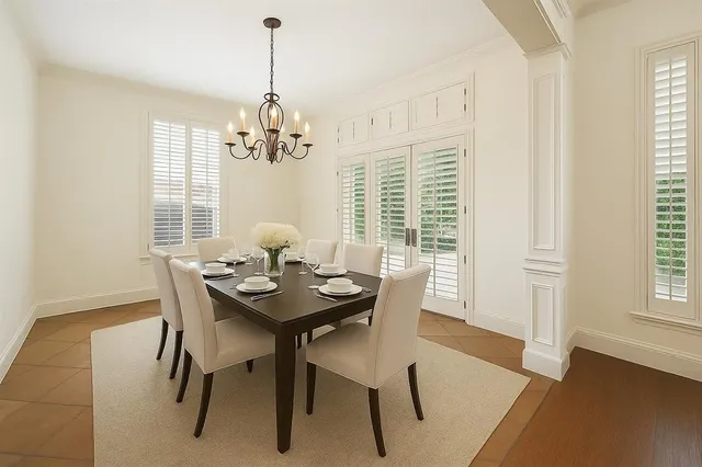 a dining room with furniture a chandelier and wooden floor