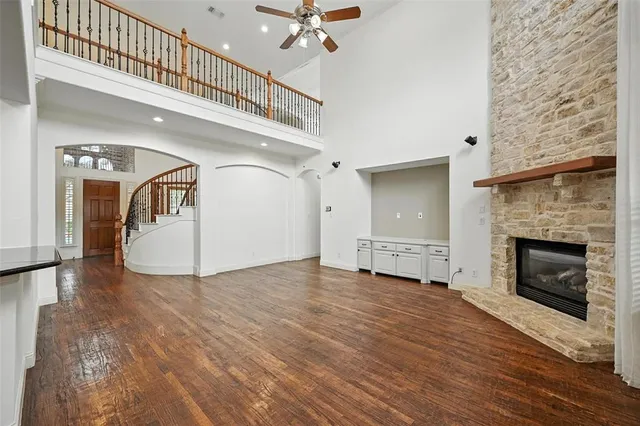 a view of a livingroom with a fireplace a chandelier and staircase