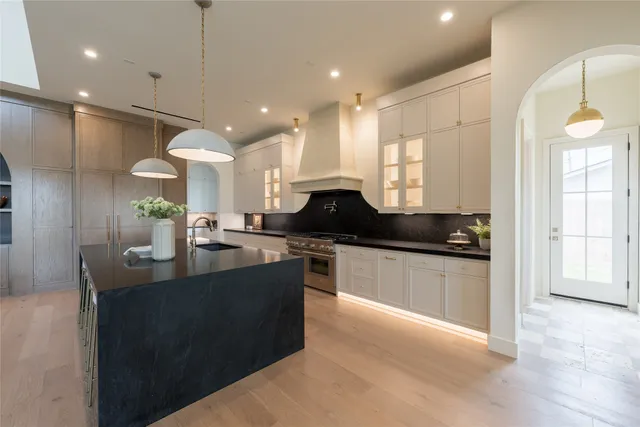 a kitchen with granite countertop a stove and a refrigerator