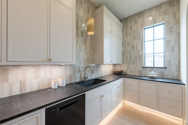 a kitchen with granite countertop white cabinets and white appliances