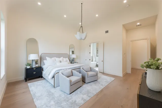 a bathroom with a sink a toilet a large mirror and shower