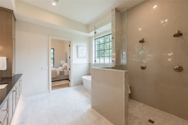 a large bathroom with double vanity sinks a large mirror and a shower