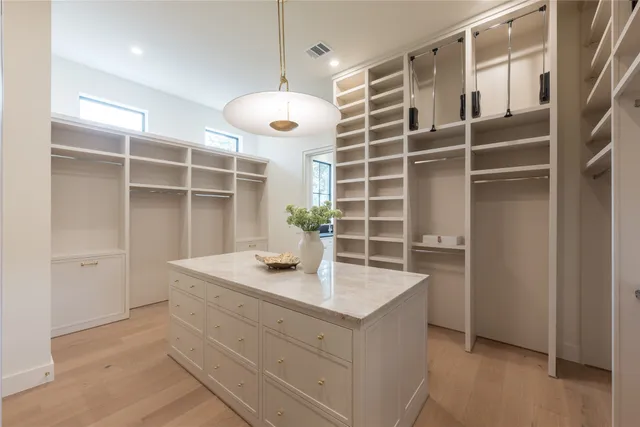 a kitchen with granite countertop a sink a stove and cabinets