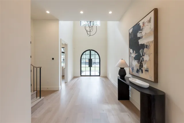 a view of a hallway with entryway wooden floor and front door