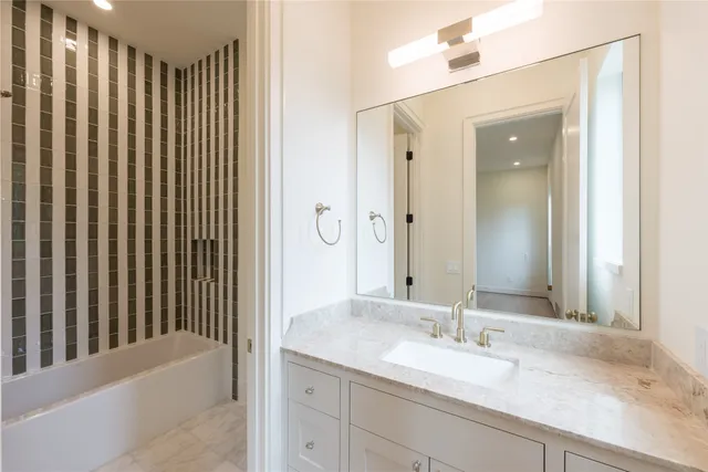 a bathroom with a bathtub and shower