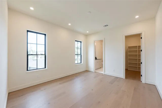 a bathroom with a granite countertop sink a toilet and shower