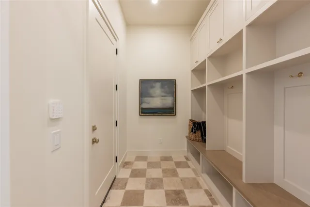 a view of a hallway with wooden floor and a living room