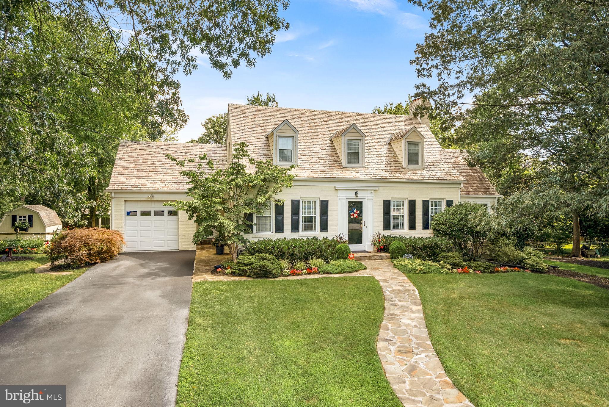 a front view of a house with a yard table and chairs