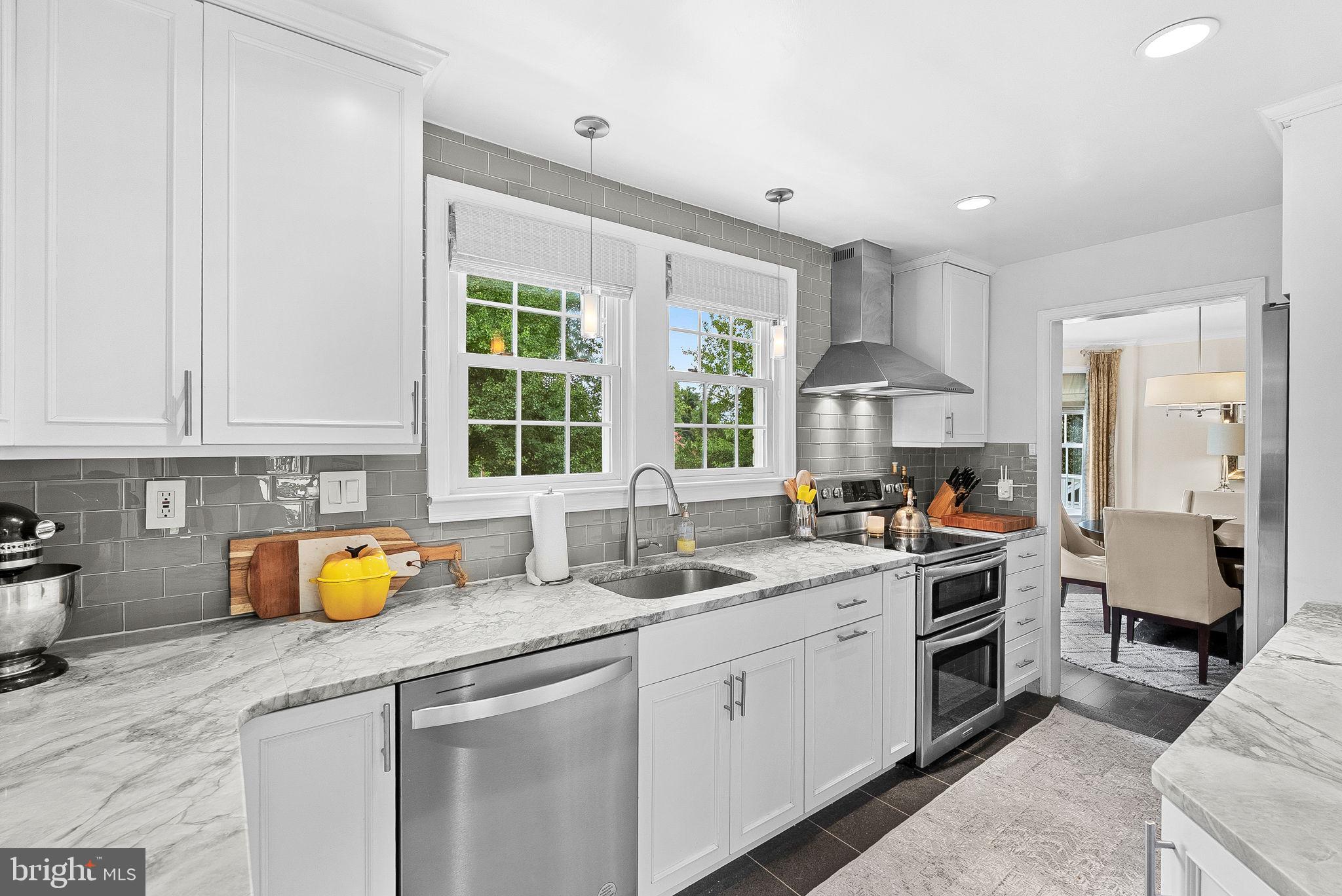 10313 Parkman Road Silver Spring, MD 20903 - Photo 14 of 61 a kitchen with a sink cabinets and window