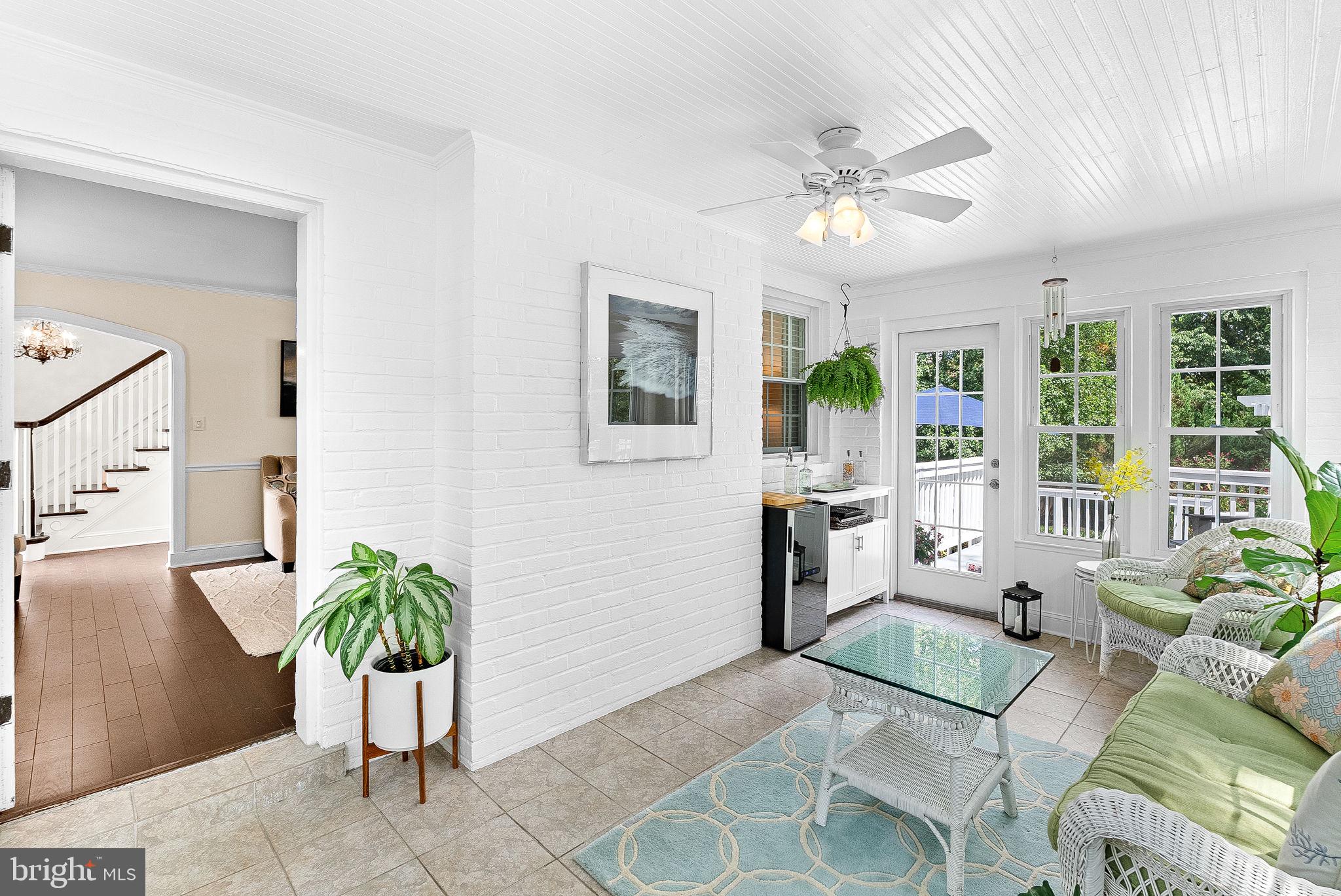 10313 Parkman Road Silver Spring, MD 20903 - Photo 16 of 61 a living room with furniture a chandelier and a potted plant
