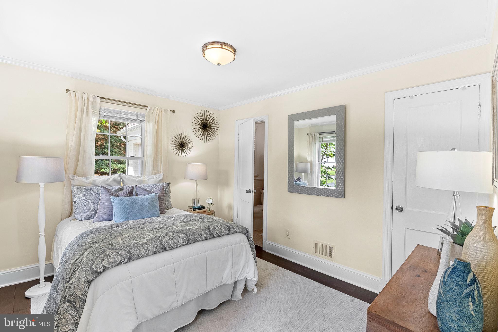 10313 Parkman Road Silver Spring, MD 20903 - Photo 23 of 61 a bedroom with a bed and a lamp