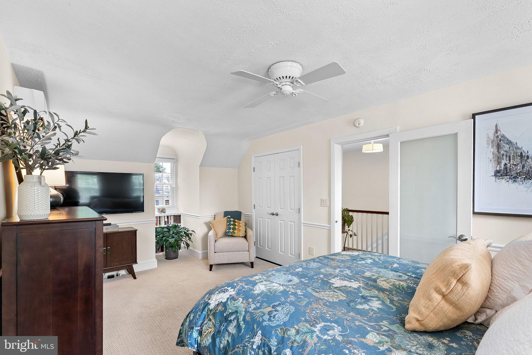 10313 Parkman Road Silver Spring, MD 20903 - Photo 25 of 61 a spacious bedroom with a bed and a flat screen tv