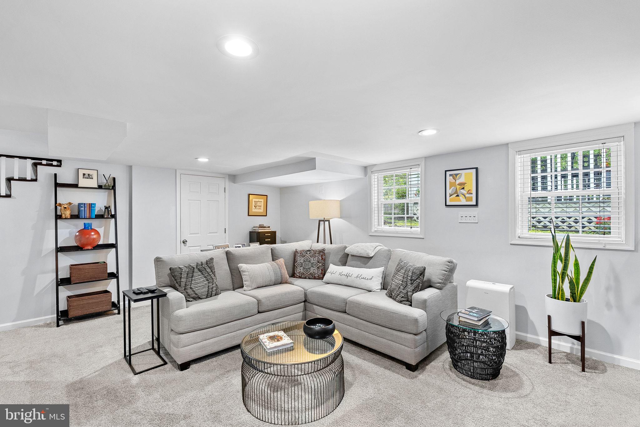 10313 Parkman Road Silver Spring, MD 20903 - Photo 37 of 61 a living room with furniture and a bookshelf