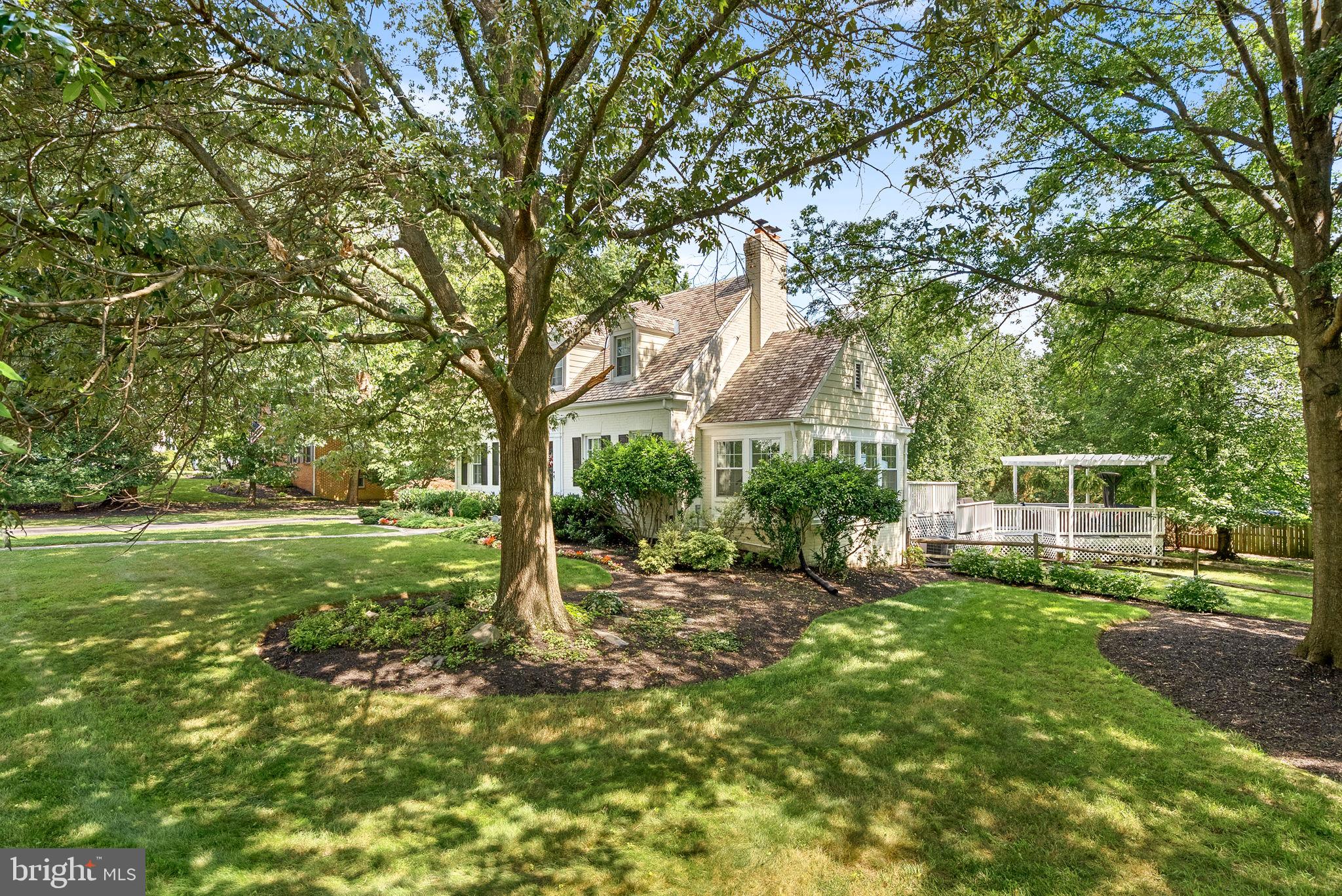10313 Parkman Road Silver Spring, MD 20903 - Photo 49 of 61 a view of a backyard with table and chairs and large trees