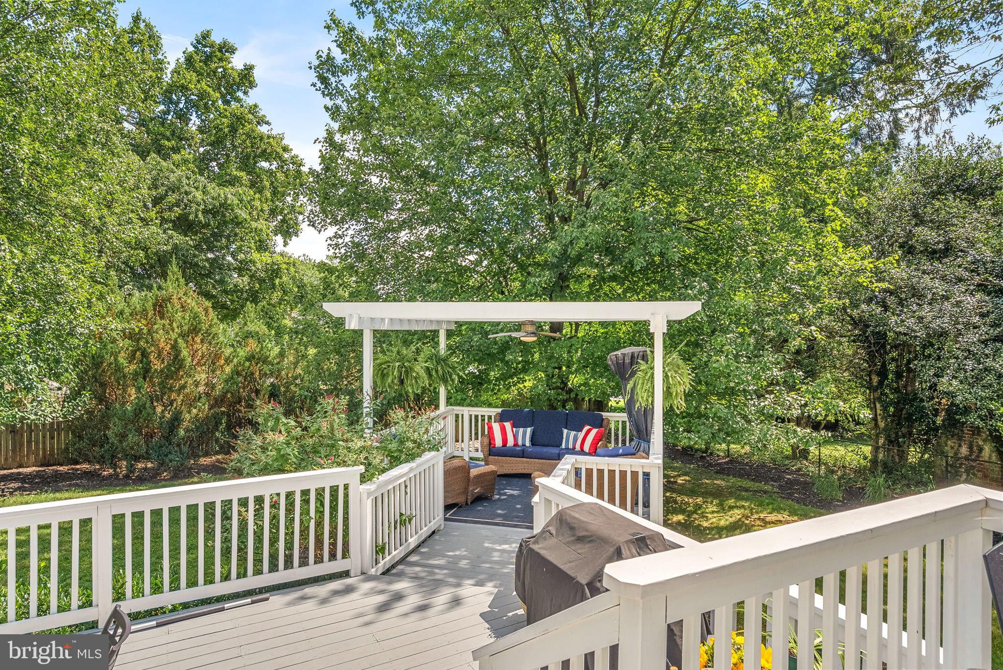 10313 Parkman Road Silver Spring, MD 20903 - Photo 53 of 61 a view of a deck with chairs a barbeque grill with wooden fence