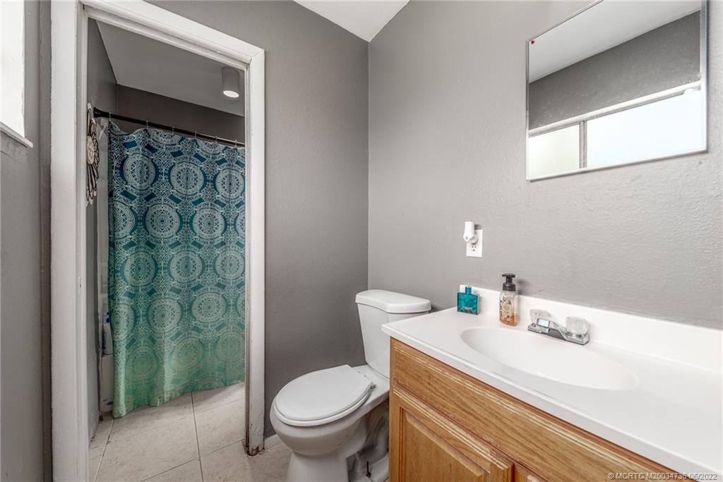 255 Southwest Homeland Road Port St. Lucie, FL 34953 - Photo 13 of 15 a bathroom with a sink toilet and shower